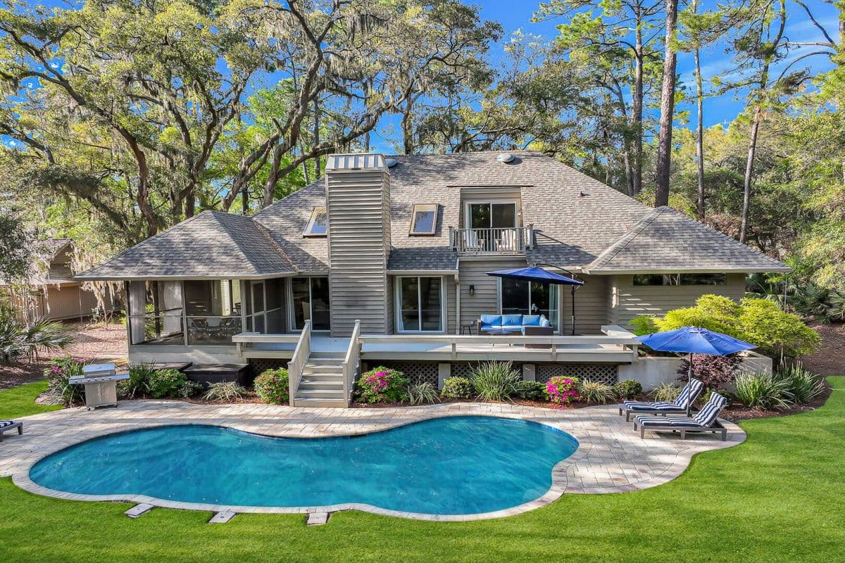 A host2coast Hilton Head home with a pool and shaded outdoor living space